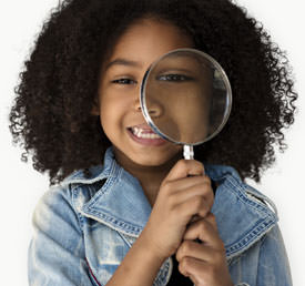 student holding a magnifying glass